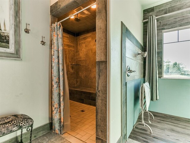 bathroom with hardwood / wood-style floors and walk in shower