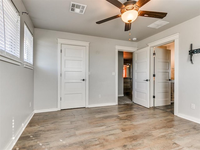 unfurnished bedroom with ceiling fan and light hardwood / wood-style floors