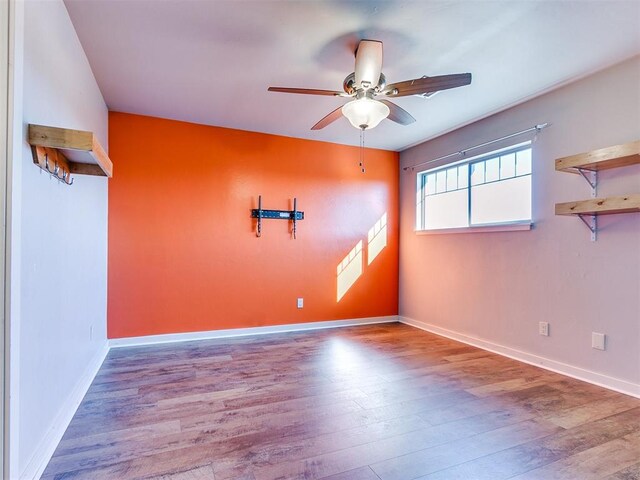 empty room with ceiling fan and light wood-type flooring