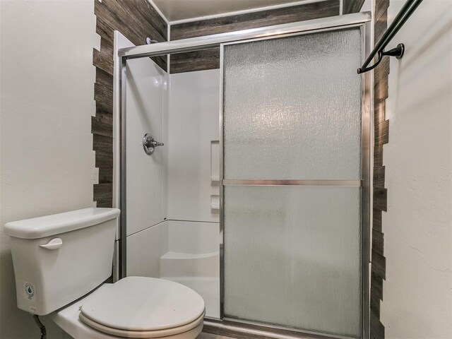 bathroom featuring toilet and walk in shower