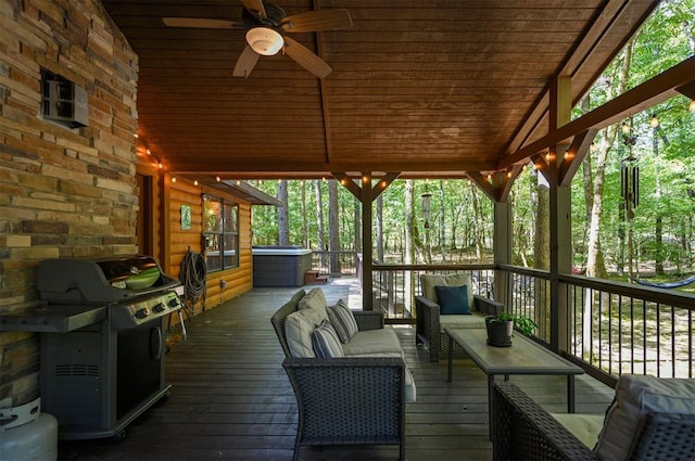 wooden deck featuring a hot tub, an outdoor living space, area for grilling, and ceiling fan