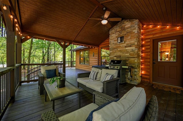 wooden terrace with grilling area, ceiling fan, area for grilling, and an outdoor hangout area