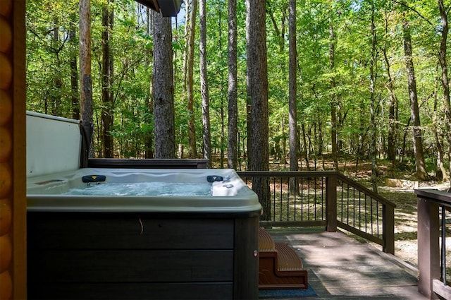 wooden terrace featuring a hot tub