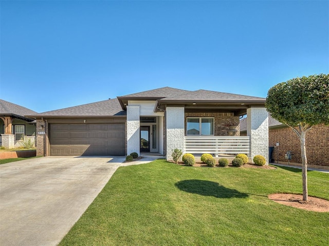 prairie-style house featuring a front lawn and a garage