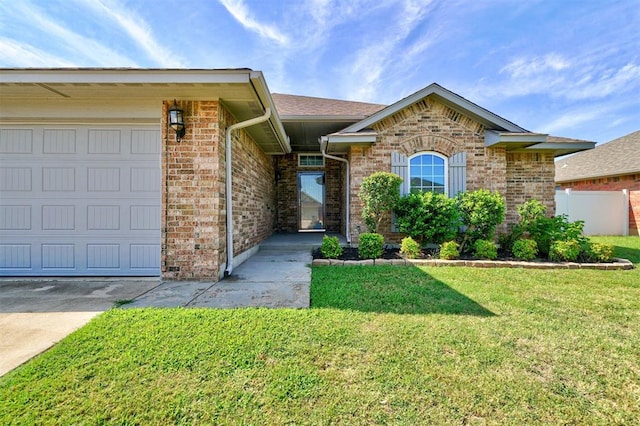 ranch-style house featuring a garage and a front yard