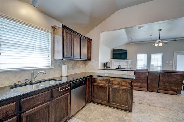 kitchen with kitchen peninsula, sink, stainless steel dishwasher, and lofted ceiling