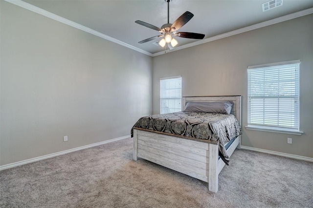 carpeted bedroom featuring ceiling fan and crown molding