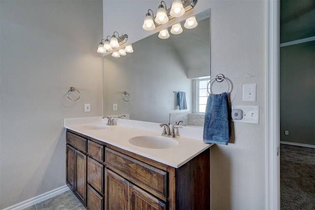 bathroom with vanity and lofted ceiling