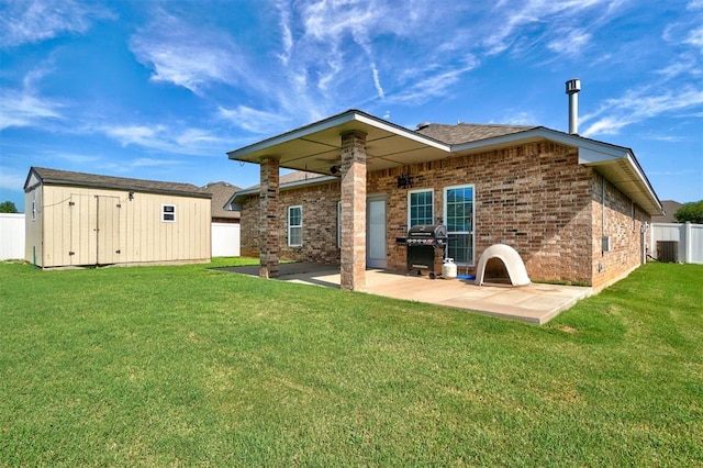 rear view of house featuring a patio area, a shed, a yard, and cooling unit