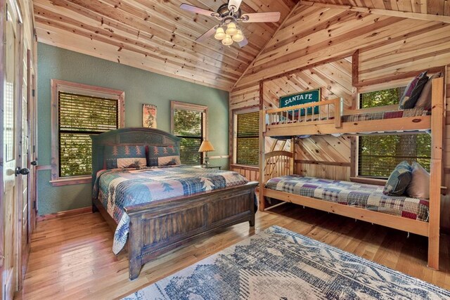 bedroom with ceiling fan, high vaulted ceiling, wood ceiling, and hardwood / wood-style flooring