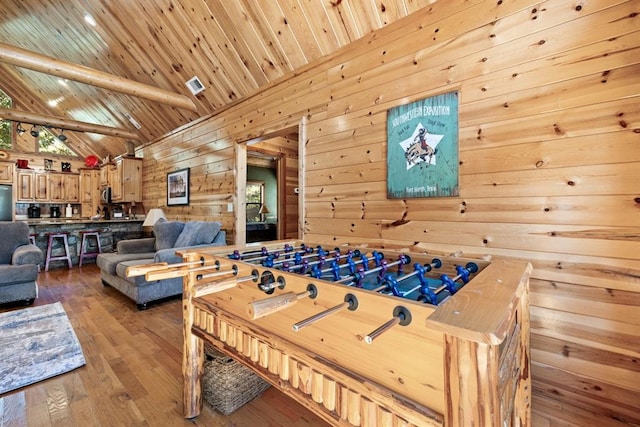 game room featuring wood ceiling, wooden walls, wood-type flooring, and lofted ceiling