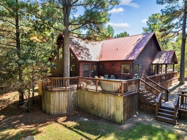 rear view of house with a wooden deck