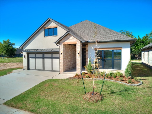 view of front of property featuring a front yard and a garage