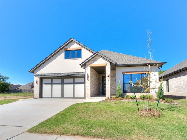 view of front of property featuring a front yard and a garage