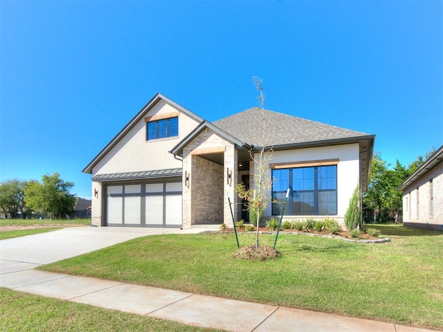 view of front of home with a front yard and a garage