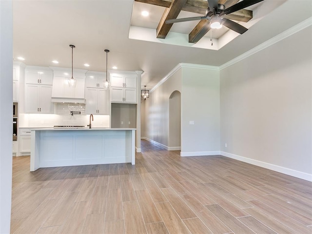 kitchen featuring pendant lighting, ceiling fan, light hardwood / wood-style floors, and white cabinetry