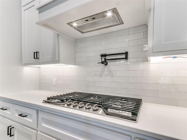 kitchen featuring white cabinetry, stainless steel gas cooktop, and tasteful backsplash