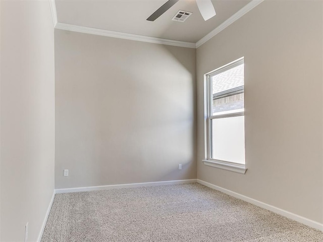 carpeted spare room with ceiling fan and ornamental molding