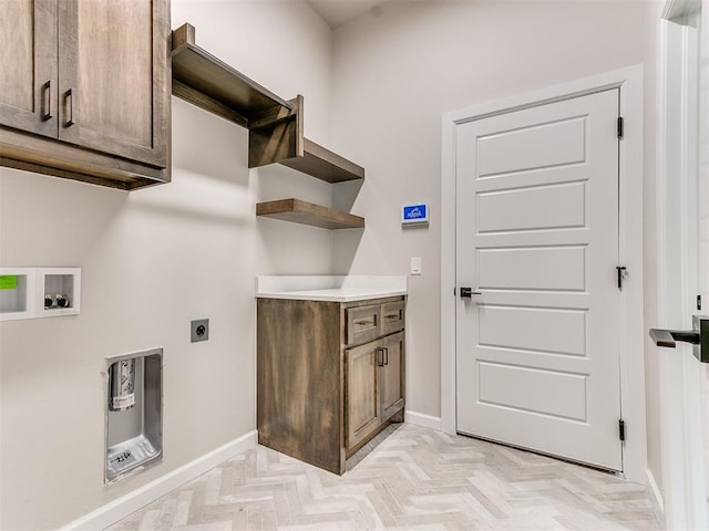 clothes washing area featuring hookup for an electric dryer, washer hookup, cabinets, and light parquet floors