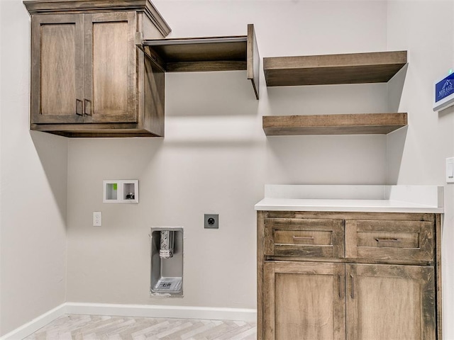 laundry area with hookup for an electric dryer, hookup for a washing machine, and light parquet floors