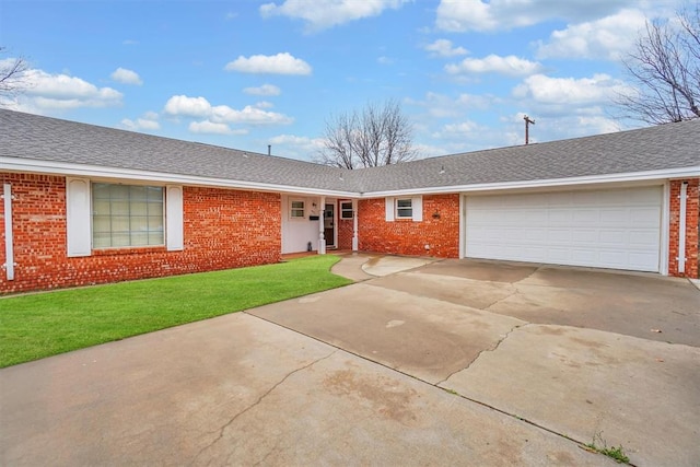 ranch-style house featuring a garage and a front yard