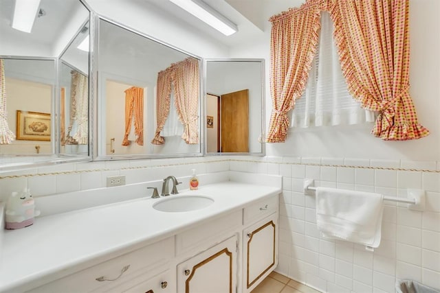 bathroom featuring vanity, tile patterned floors, and tile walls