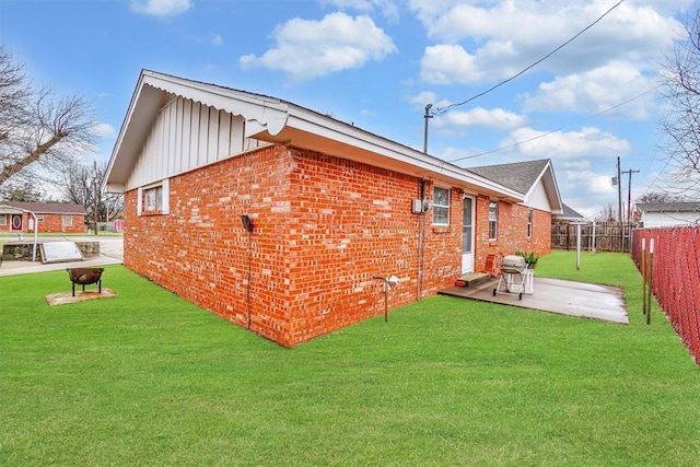 rear view of property with a patio area and a lawn