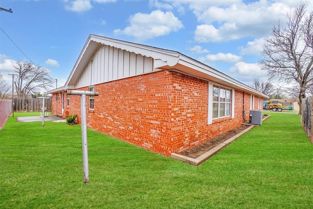 view of home's exterior with a yard and central air condition unit