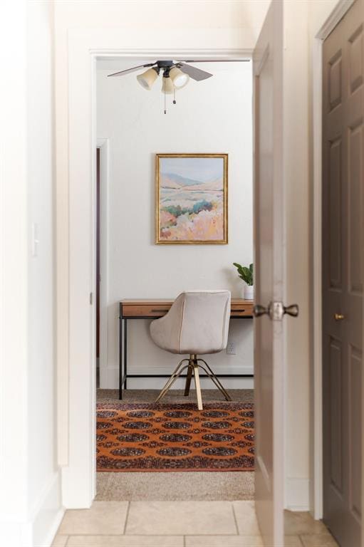 tiled office featuring ceiling fan