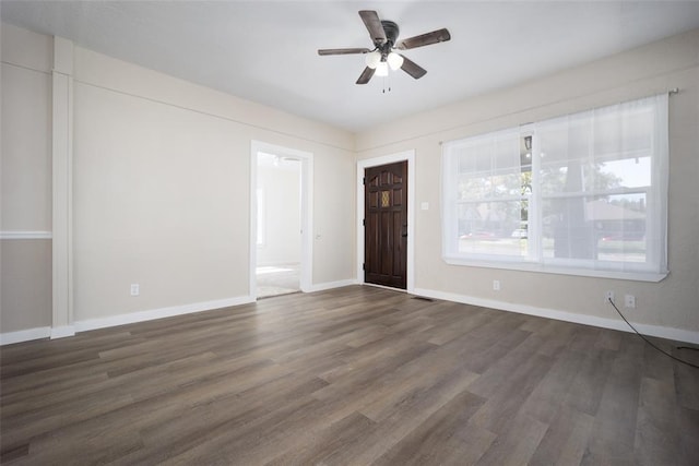 spare room with ceiling fan and dark hardwood / wood-style floors