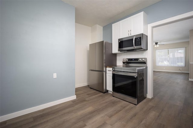 kitchen with ceiling fan, wood-type flooring, white cabinetry, and stainless steel appliances