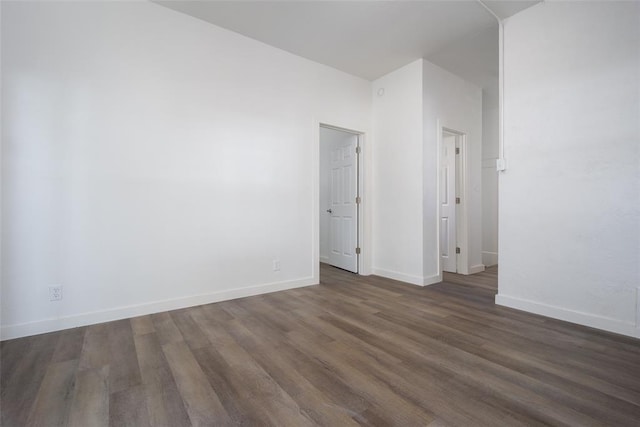 unfurnished room featuring dark hardwood / wood-style floors