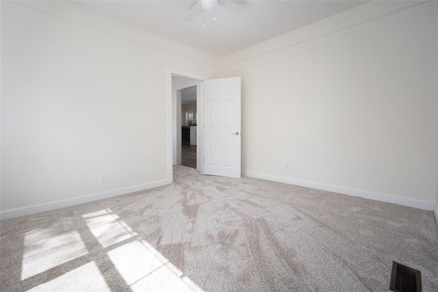 carpeted spare room with ceiling fan