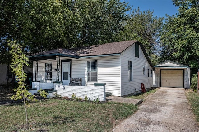 view of front of home featuring an outbuilding, a front yard, a garage, and covered porch