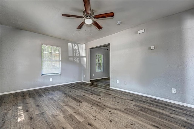 unfurnished room featuring dark hardwood / wood-style flooring and ceiling fan