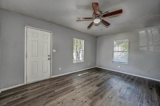 unfurnished room with dark hardwood / wood-style flooring and ceiling fan