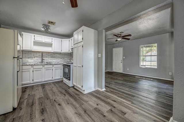 kitchen featuring white cabinets, hardwood / wood-style floors, and white appliances