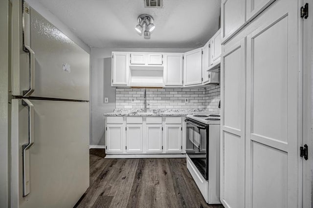 kitchen with backsplash, white appliances, dark wood-type flooring, sink, and white cabinetry