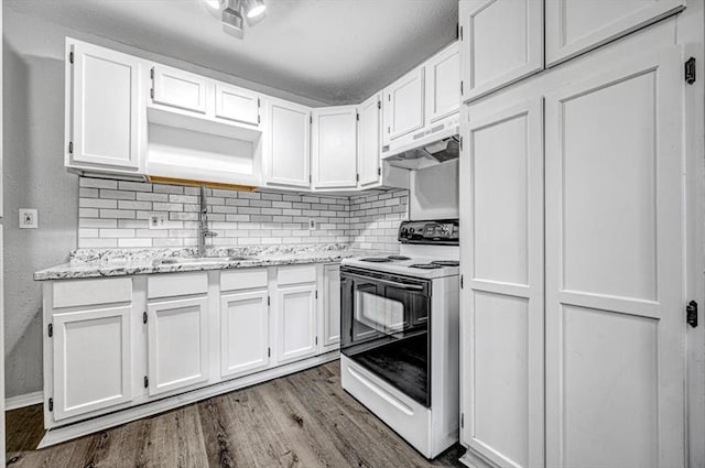 kitchen featuring white electric range oven, custom range hood, white cabinets, and hardwood / wood-style floors