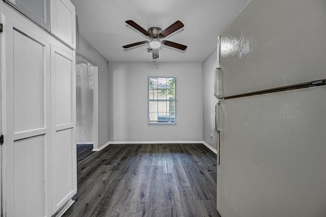 empty room featuring ceiling fan and dark hardwood / wood-style flooring