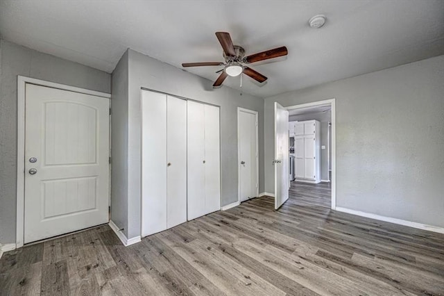 unfurnished bedroom with ceiling fan and light hardwood / wood-style floors