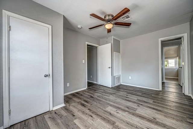 unfurnished bedroom featuring ceiling fan and hardwood / wood-style flooring