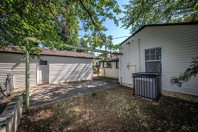 view of yard featuring central air condition unit and a patio