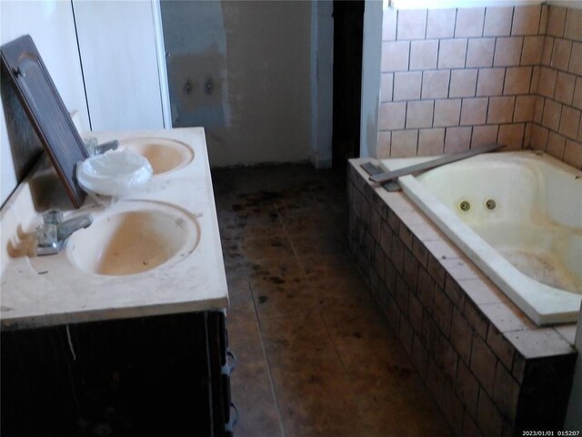 22130 10th St, Hinton, OK 73047 - full bathroom with double vanity, a jetted tub, a sink, and tile patterned floors