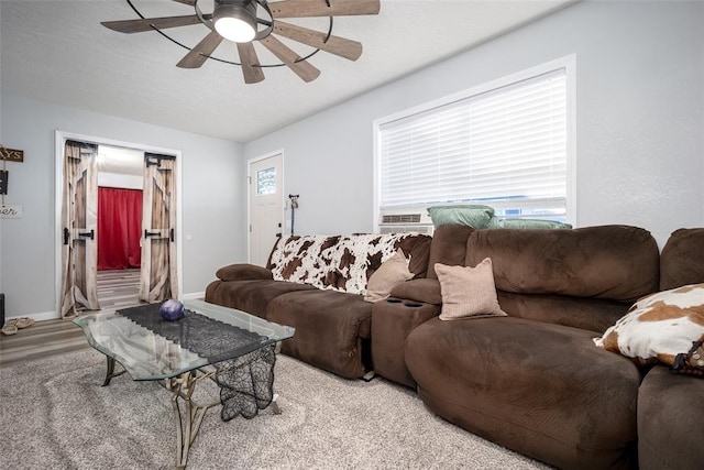 living room with ceiling fan and light hardwood / wood-style flooring