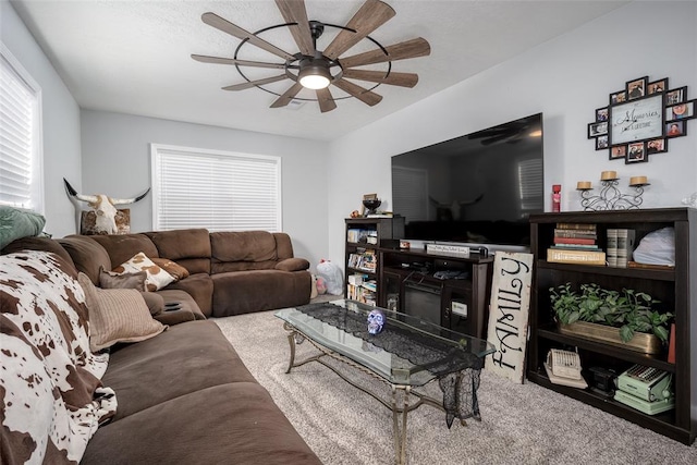 carpeted living room with ceiling fan