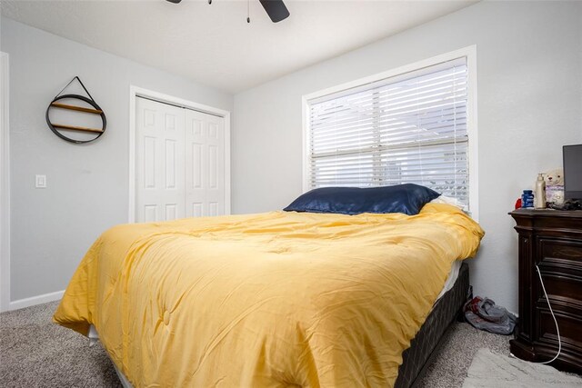 bedroom with ceiling fan, a closet, and carpet