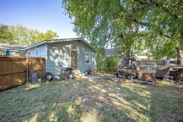 rear view of property with a lawn