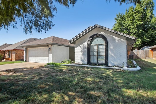 single story home with a garage and a front lawn