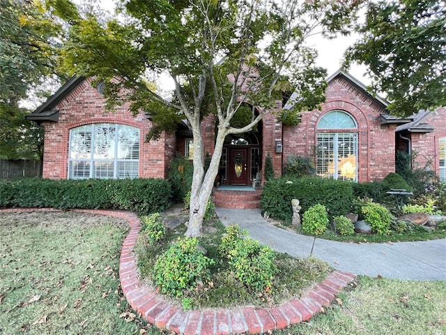 single story home featuring brick siding